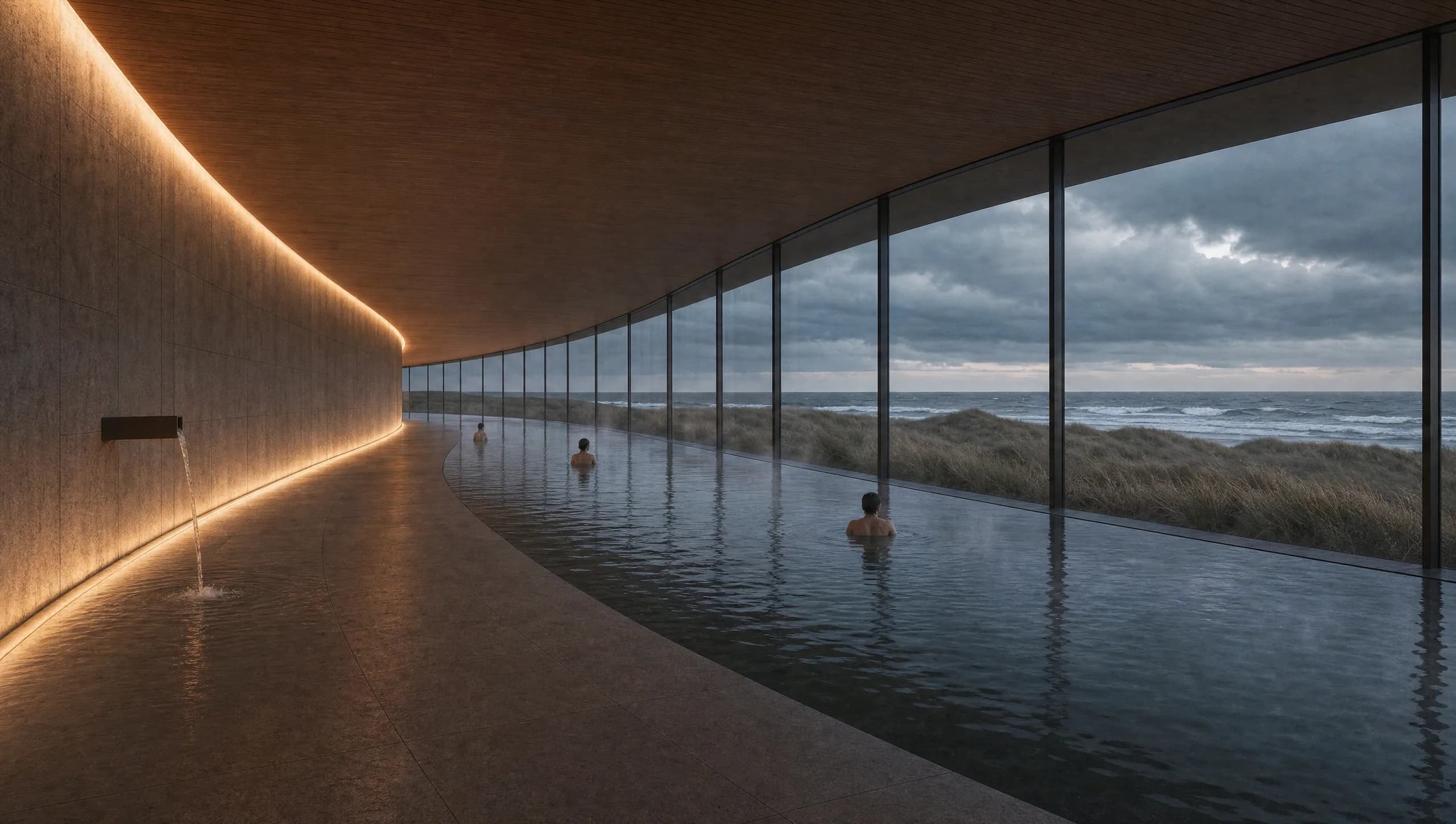 Concept view of a curving thermal bathing hall following the arc of the ring, a long dark still pool running beside a honed stone wall, with a continuous band of glazing framing marram-grass dunes and a grey North Sea horizon.